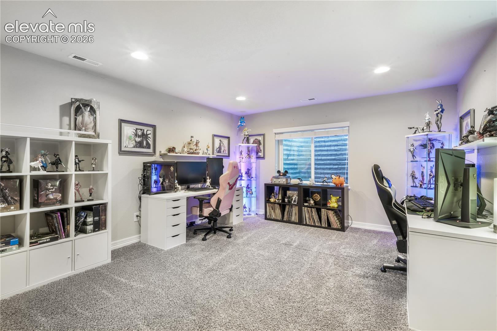 Recessed ceiling lighting, light gray wall paint, and gray carpet flooring