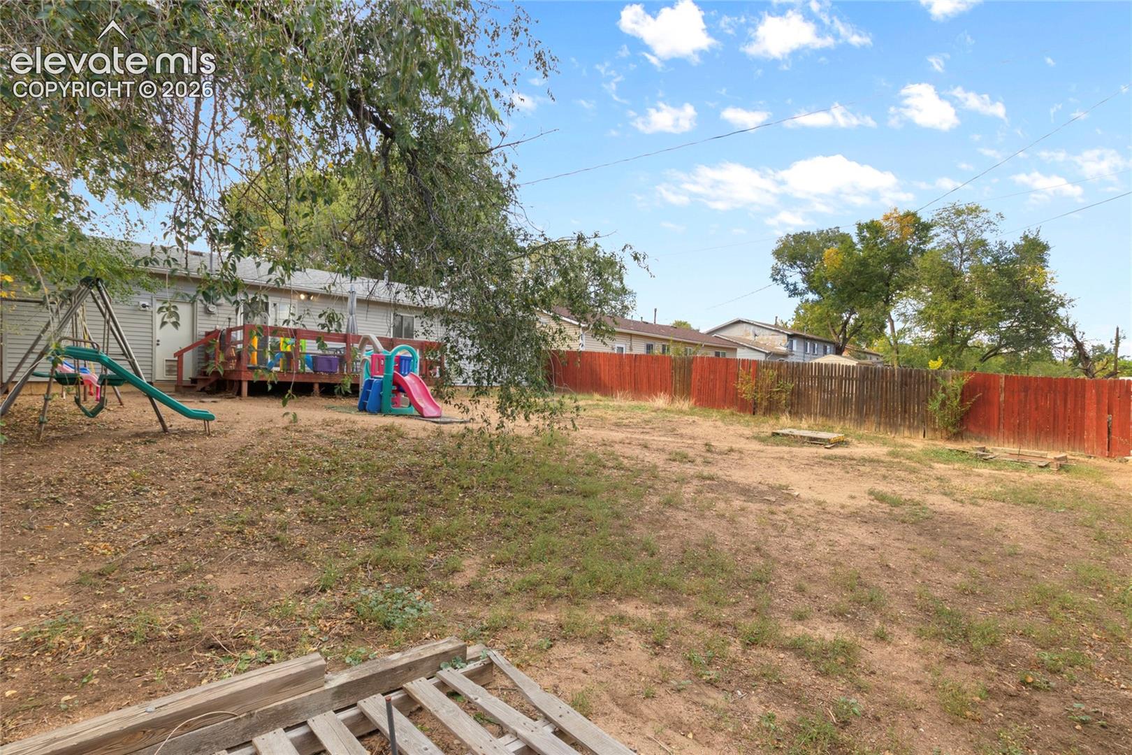 Fully fenced in back yard with gate access to fenced front yard and the back garage entrance
