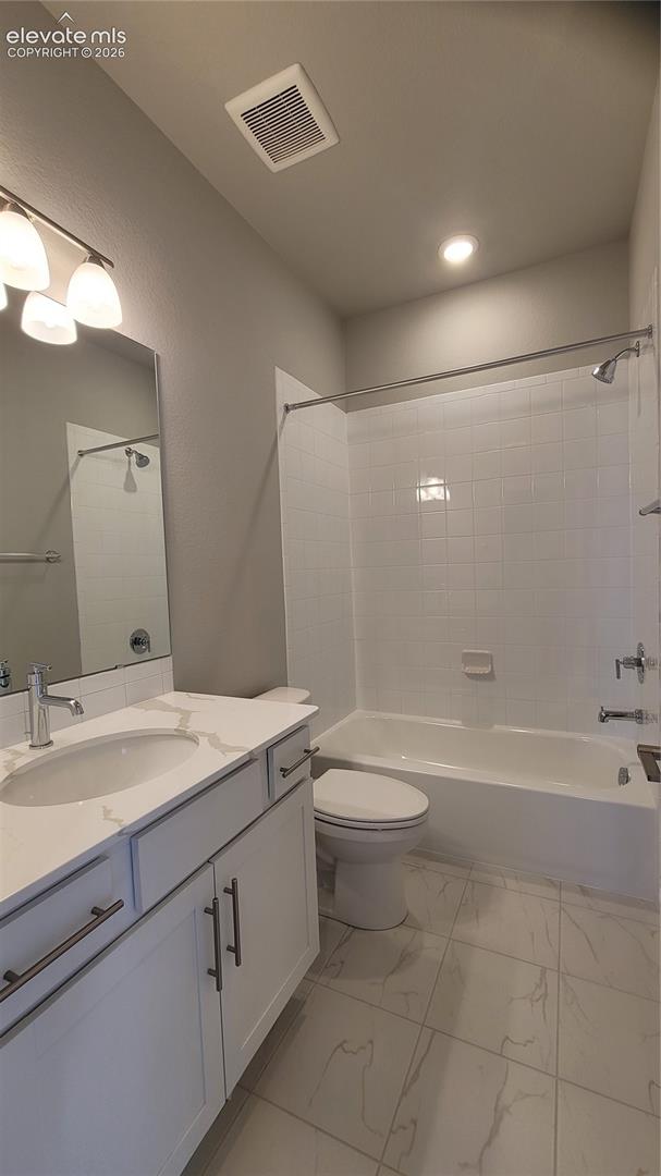 Full bathroom on upper level with quartz countertop and tile surrounds! 