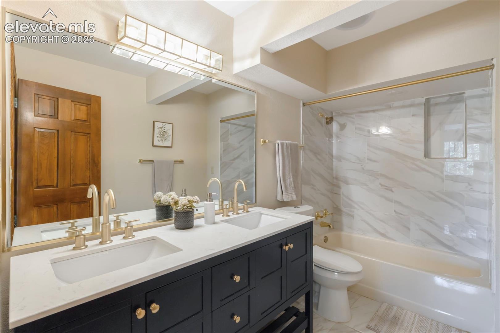 Dual vanity with integrated sinks and gold-tone hardware
