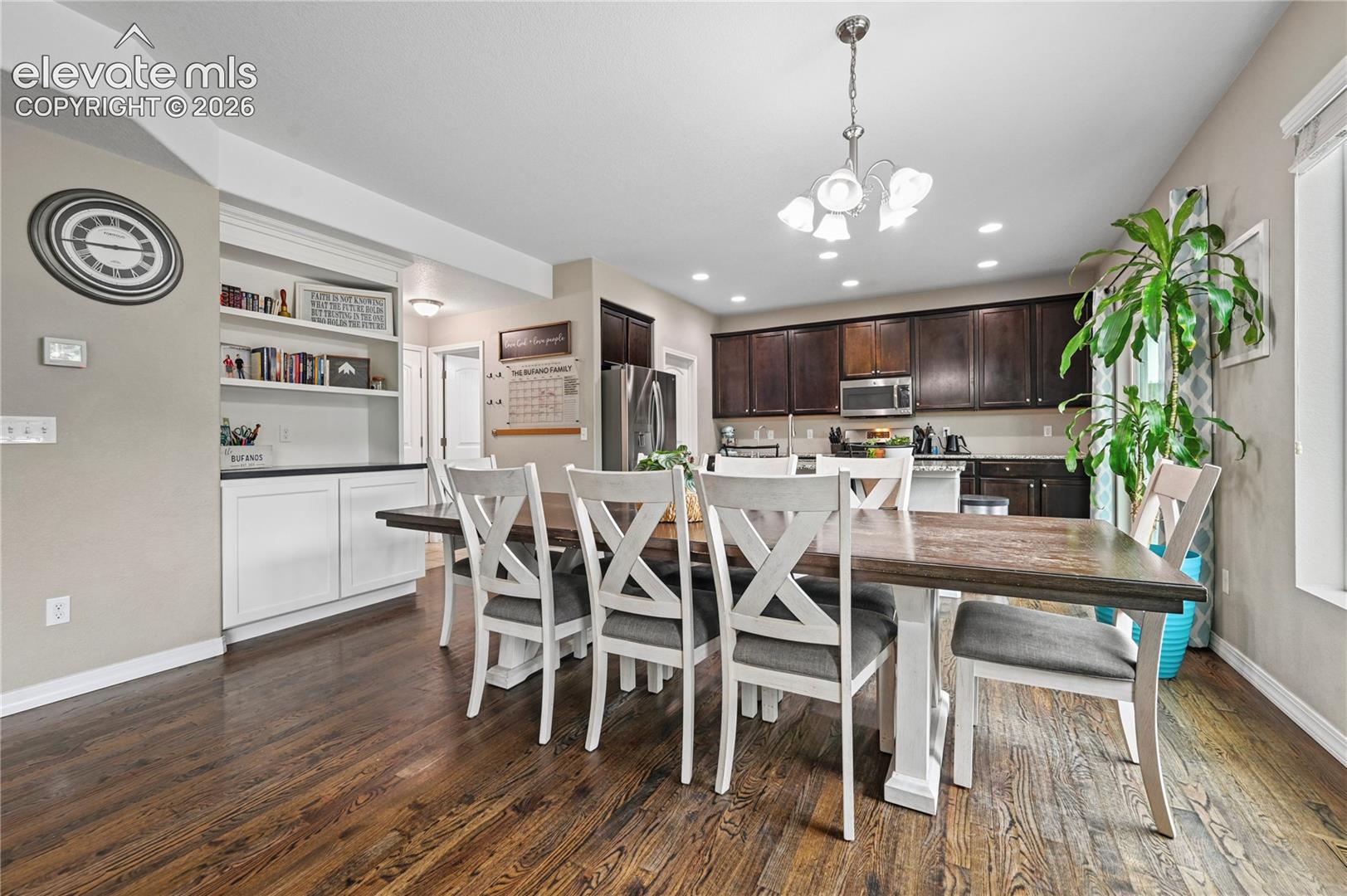 There is extra built-in cabinetry and shelves by your dining room that add to your already-impressive cabinetry and full pantry.  The garage entry & main level powder room are just there in the back hallway.