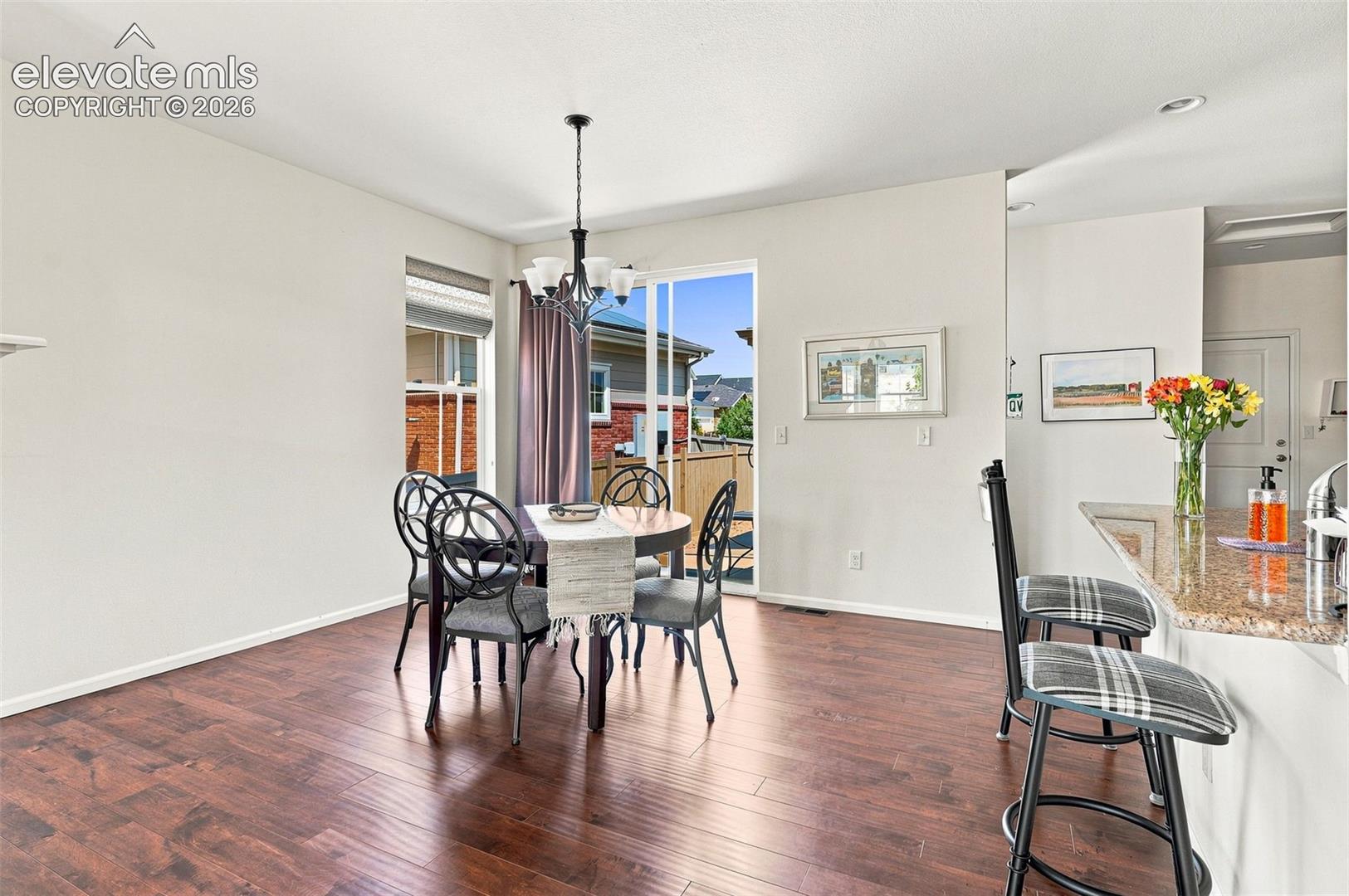 Light, bright, and spacious with other side of wrap around fireplace; overlooking patio