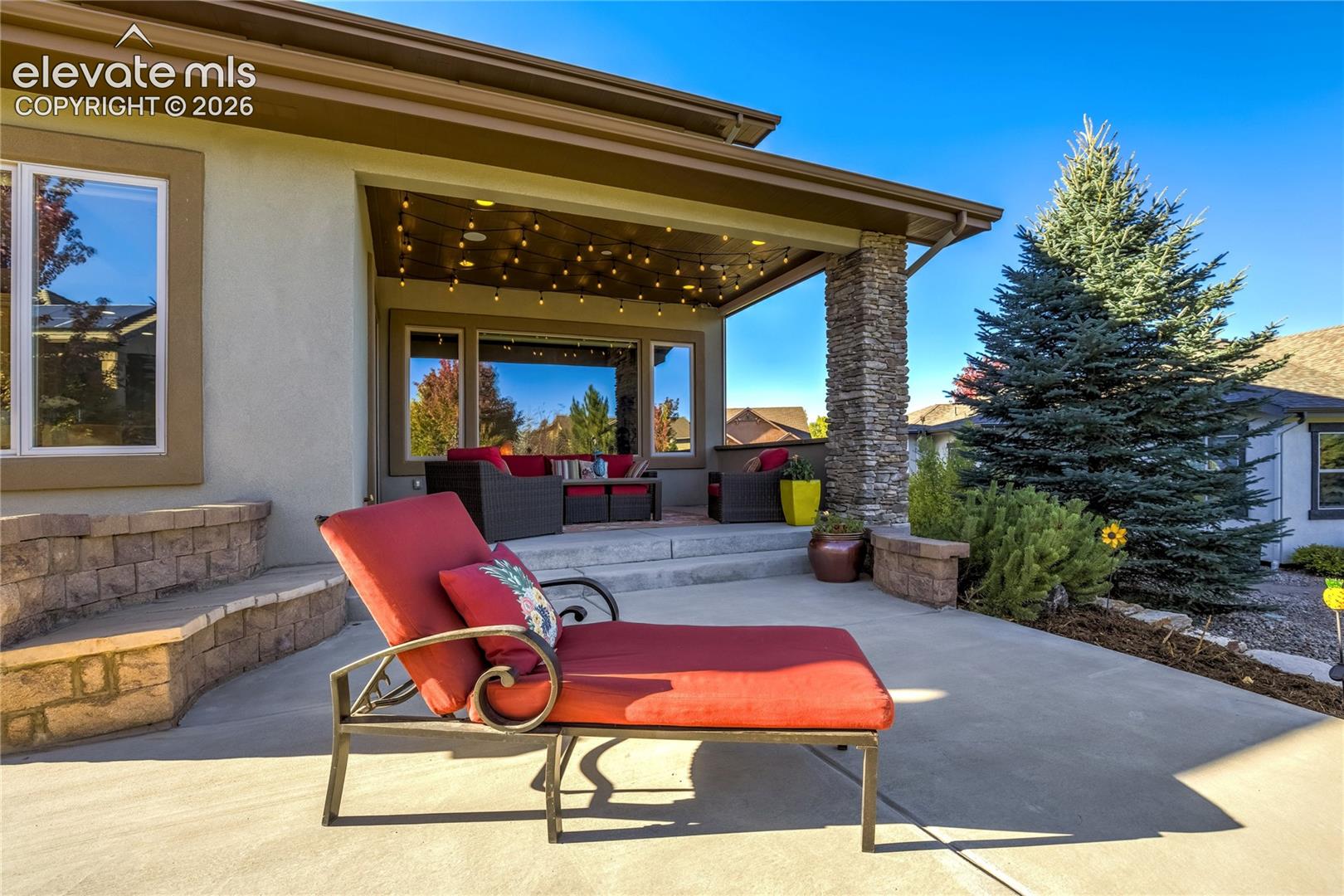A built-in gas fire pit creates a natural gathering place beneath Colorado's open skies, complemented by a spacious patio, established landscaping + comfortable areas to relax and entertain.