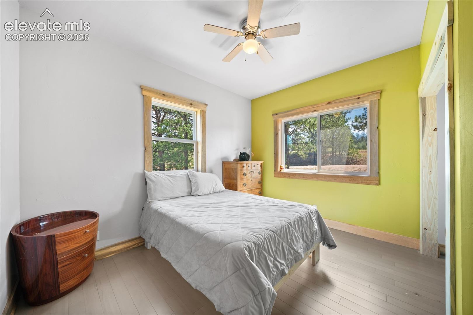Main-level bedroom with large windows and natural light.