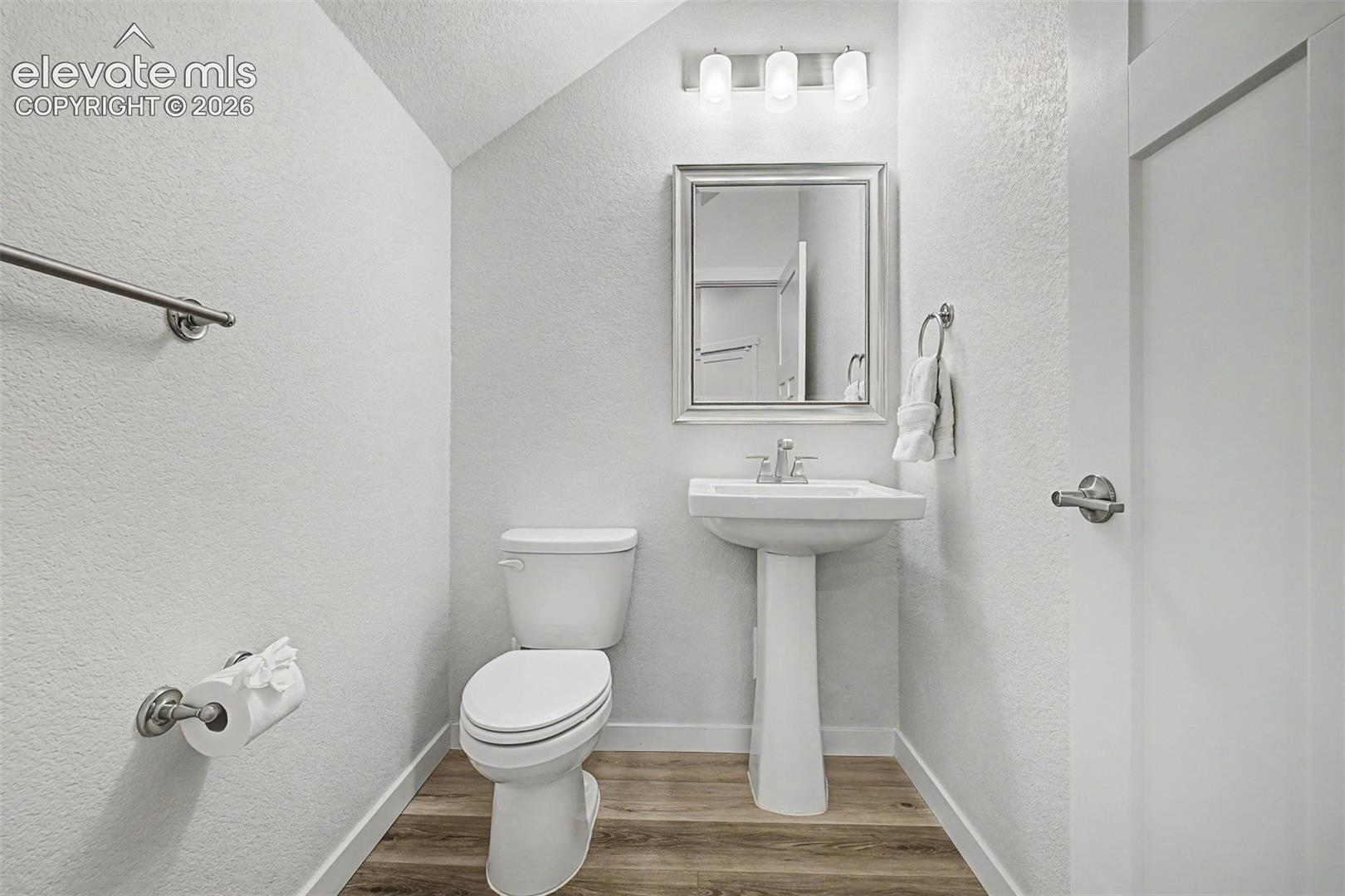 Tucked conveniently on the main floor, the powder bath is clean and classic, with a pedestal sink, brushed nickel fixtures, a beveled mirror, and thoughtful finishes that punch above their weight for a guest-ready space.