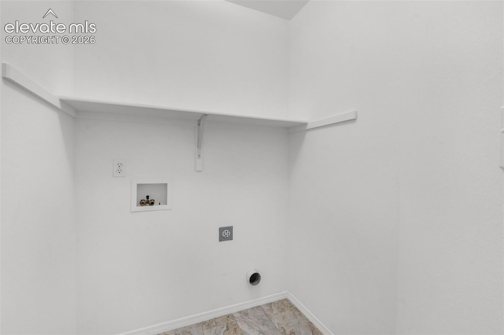 Built-in shelving, laundry hook-ups, and patterned flooring
