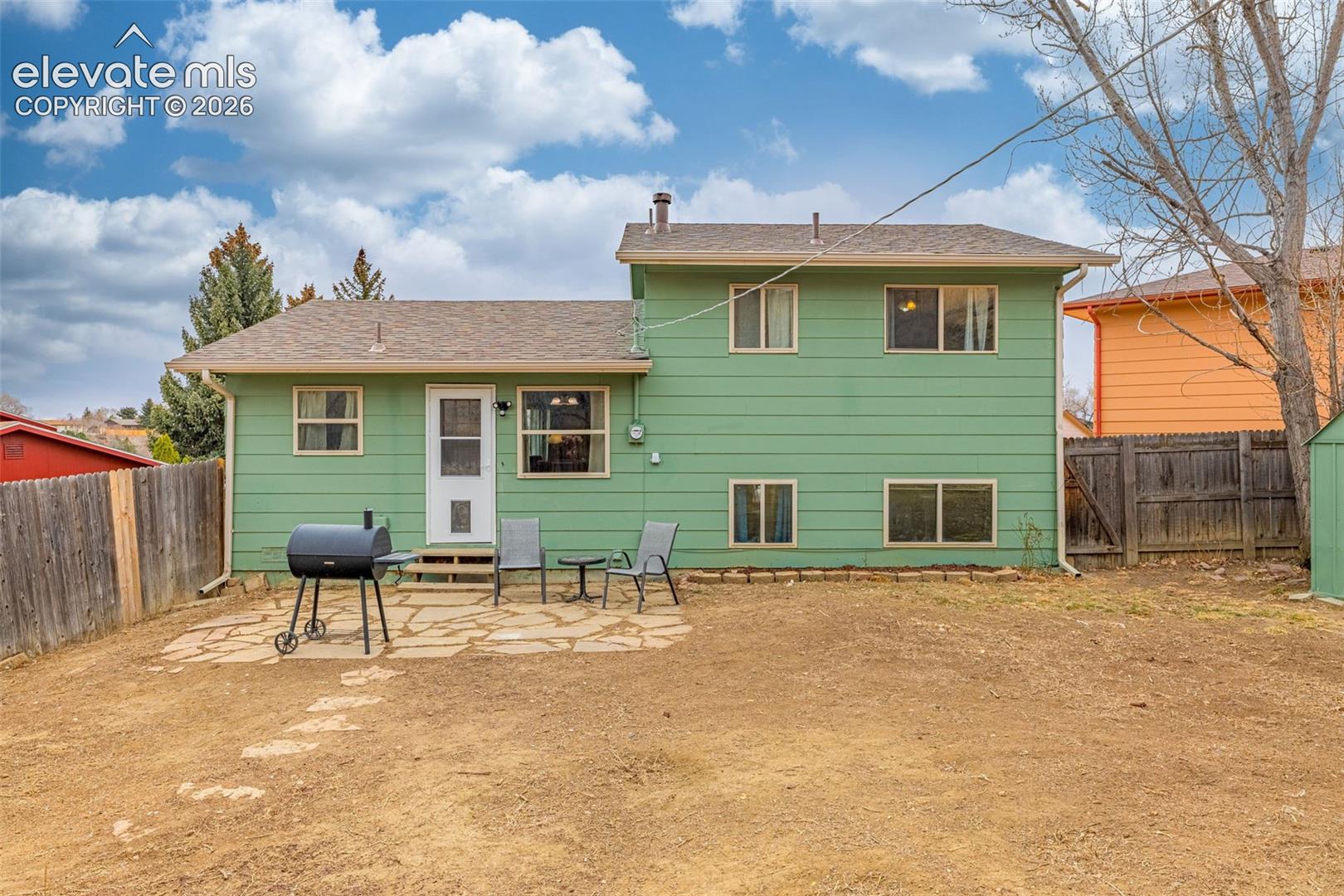 Exterior featuring horizontal siding, a flagstone patio, and a fenced backyard