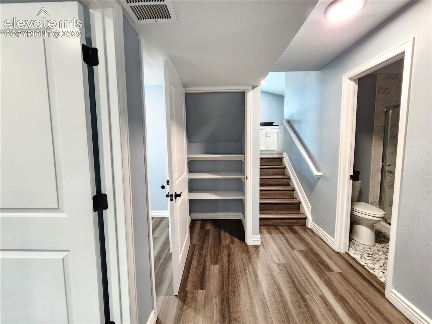 Functional lower=level landing offering a spacious built-in pantry closet