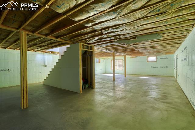 Unfinished below grade area featuring stairs
