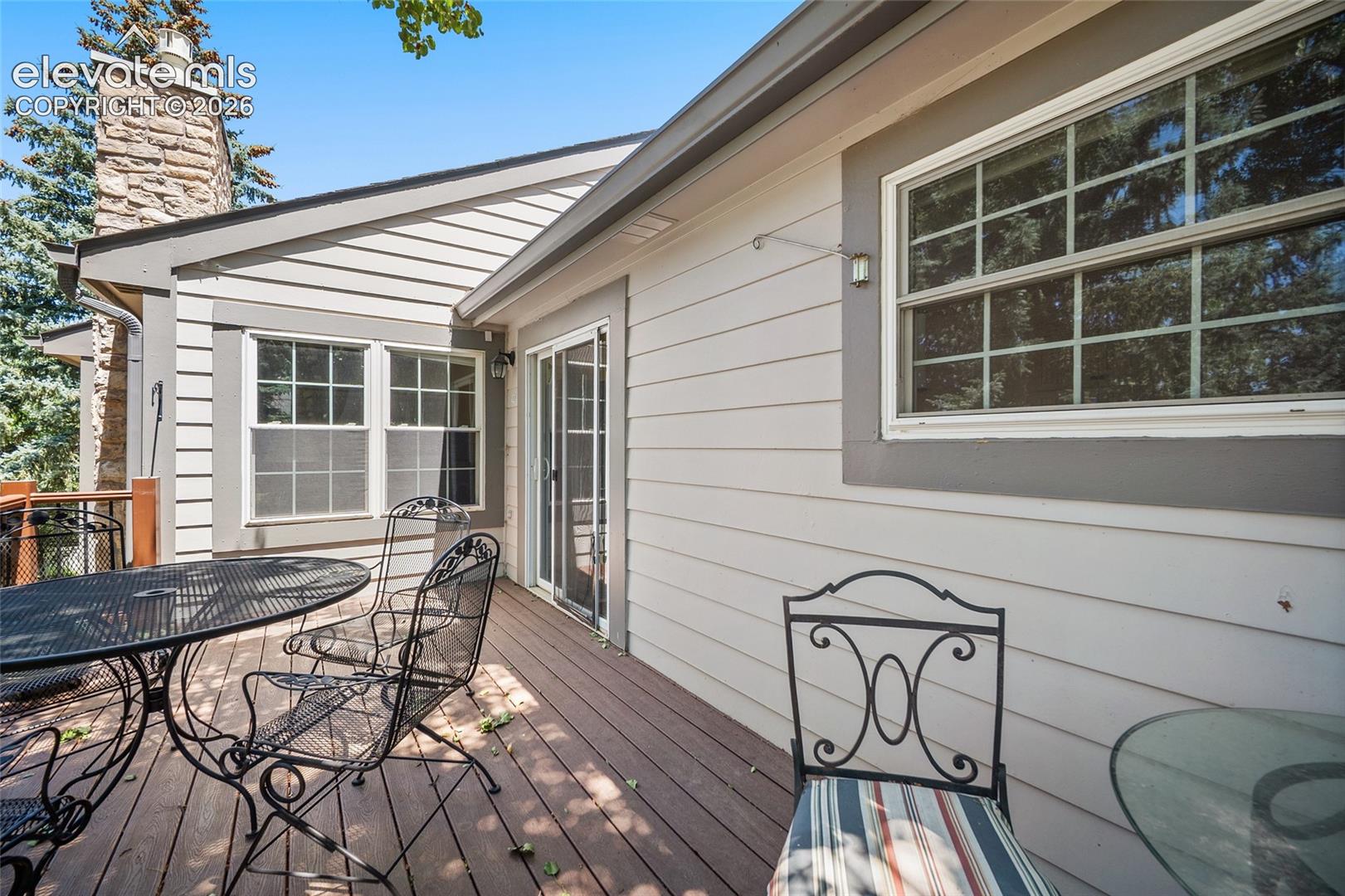 Deck off of the kitchen overlooking grassy areas. 