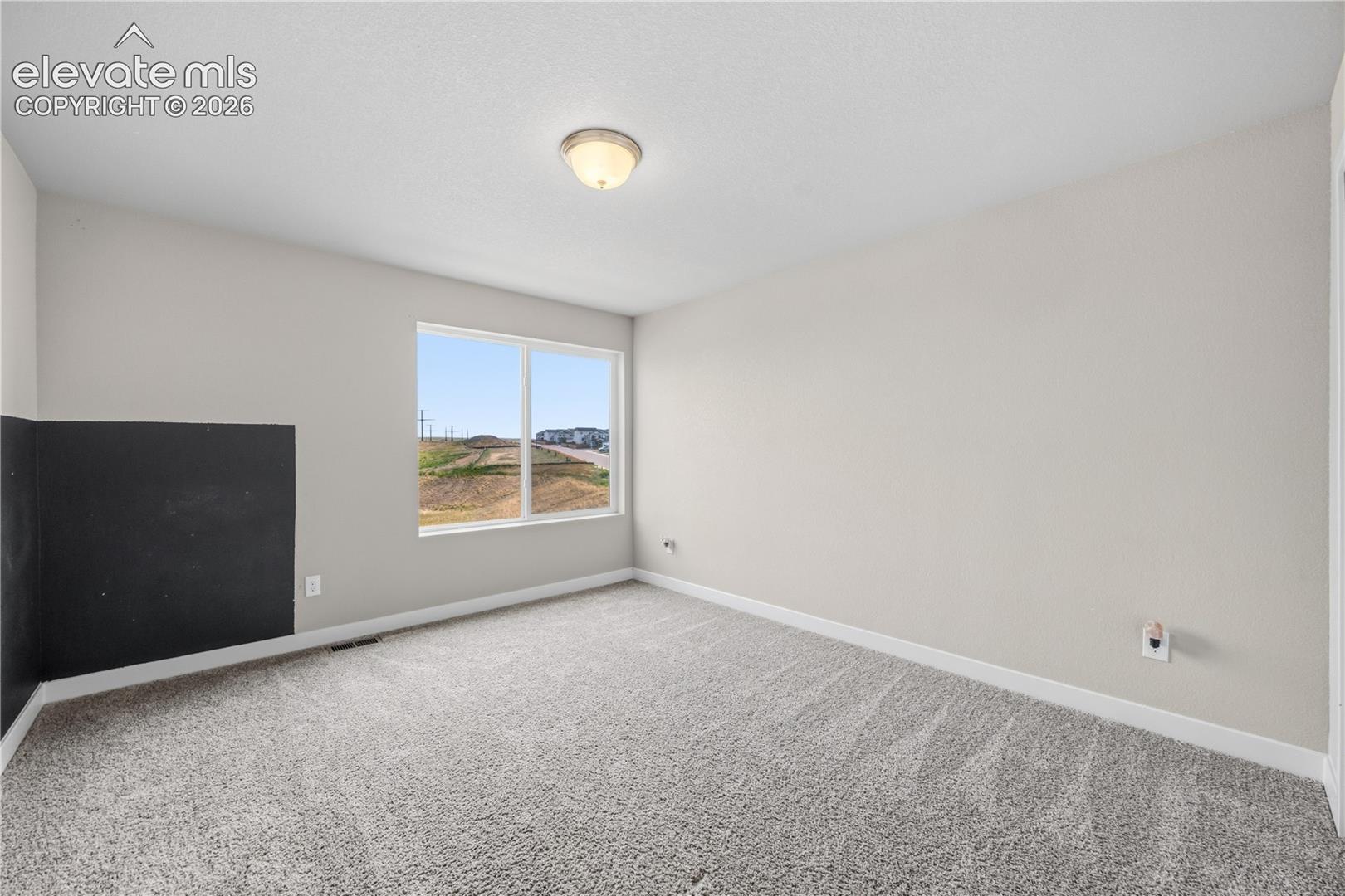 Bedroom #2 has neutral carpet.