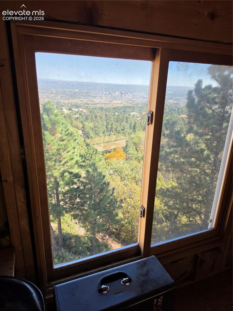Wood-framed window offering expansive distant scenery