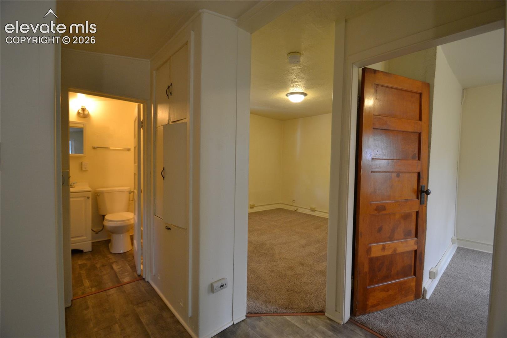 Hallway to bathroom, living room, and bedroom