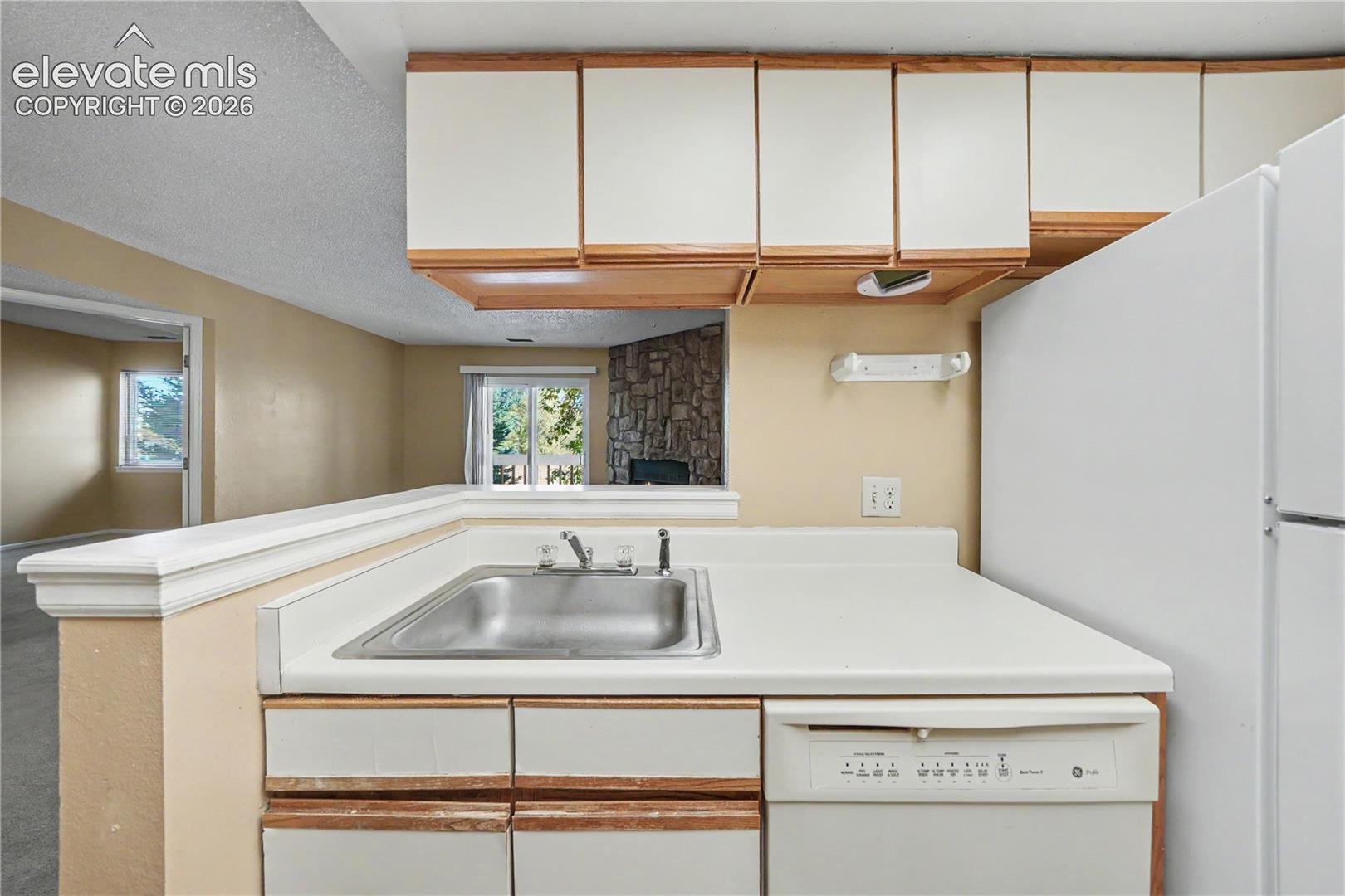 Kitchen with laminate counters and white appliances
