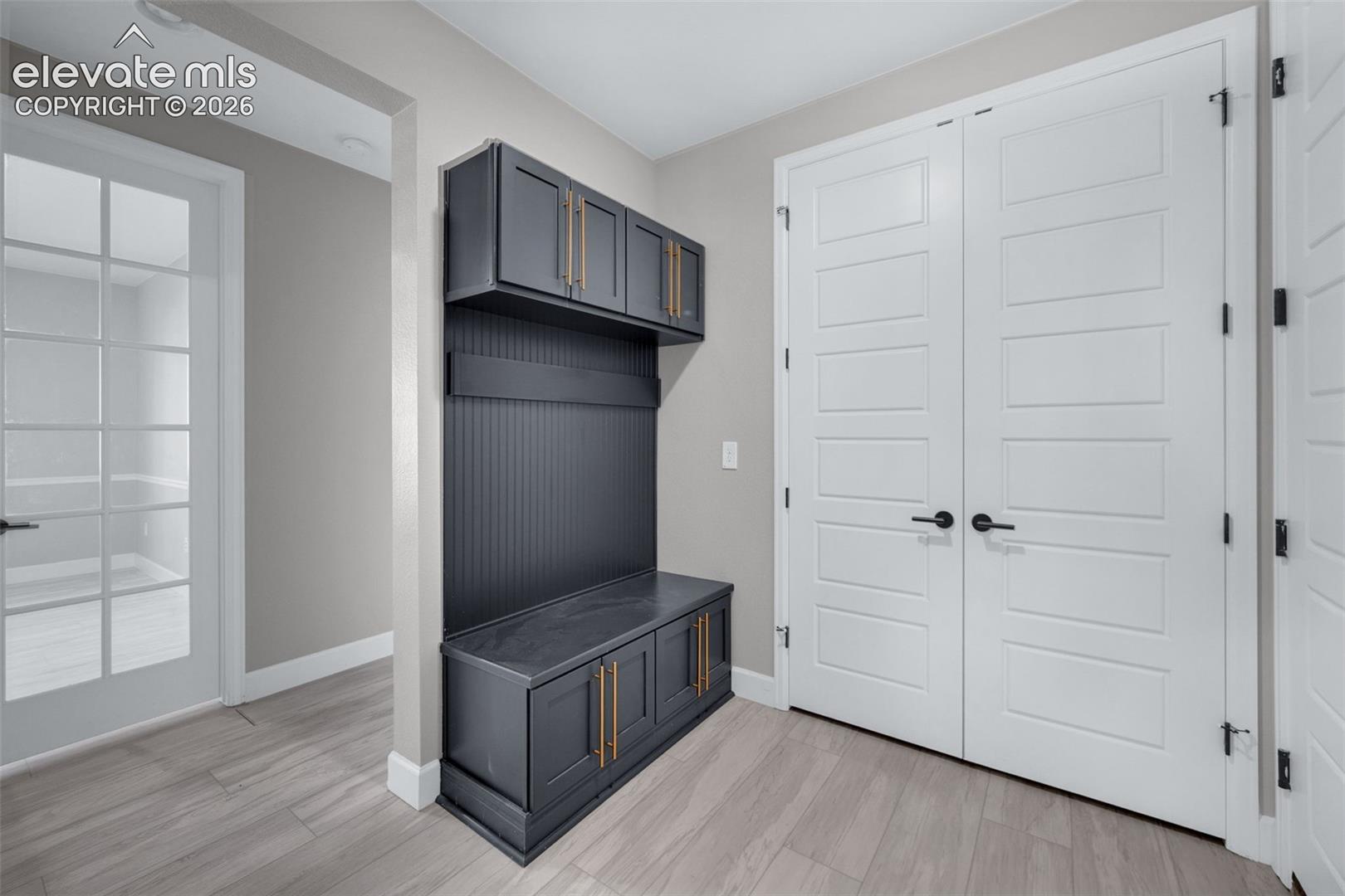 Spacious Mud Room With Coat Closet And Built In Bench