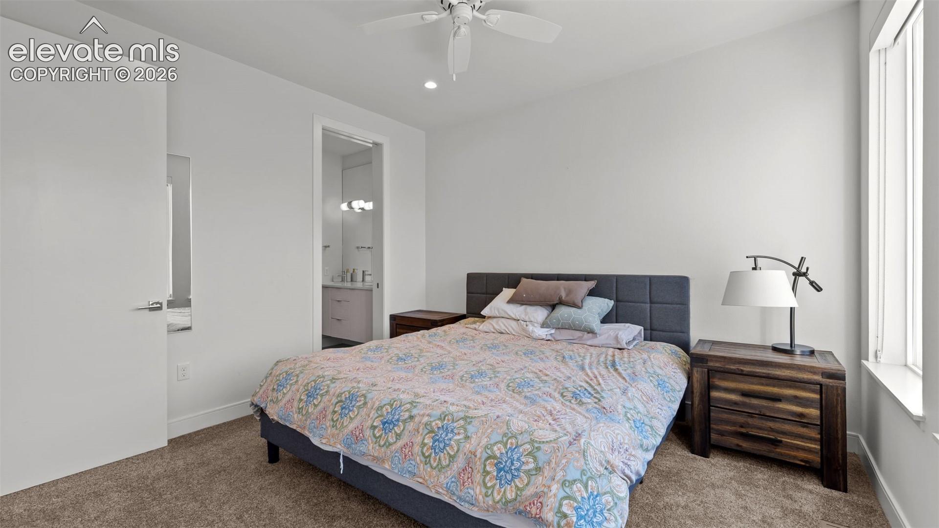Bedroom featuring neutral wall paint, carpeted flooring, a ceiling fan, recessed lighting, and a large window
