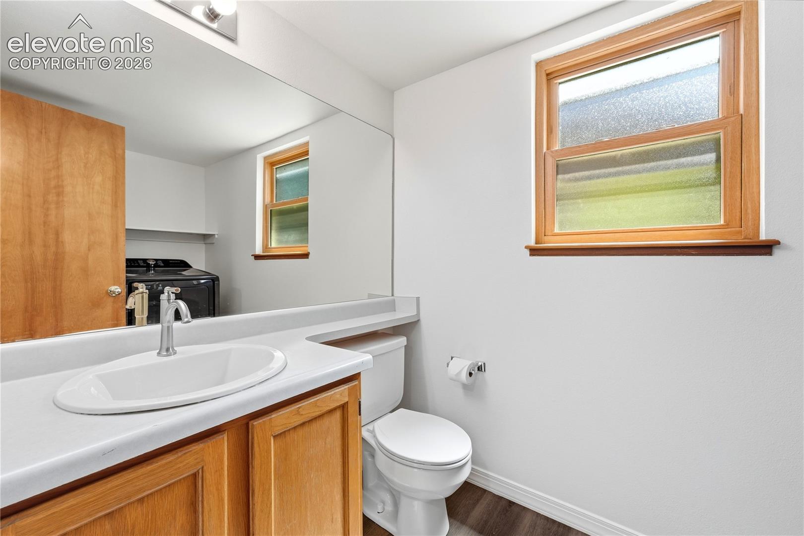 Main level half bath with a full-width mirror