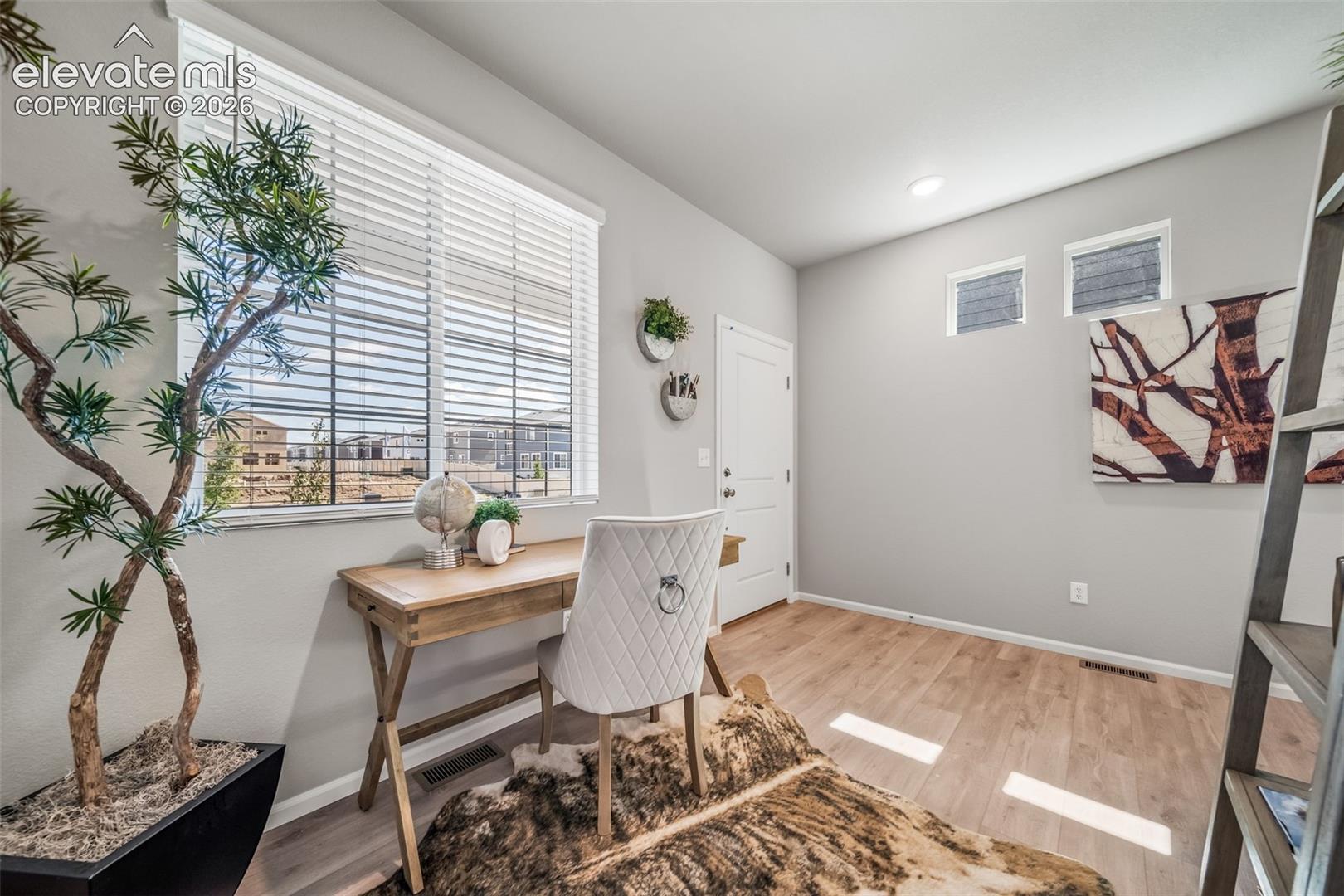 Wood-finish flooring, multiple window placements, recessed lighting, and a neutral wall color
*photos of a model home*