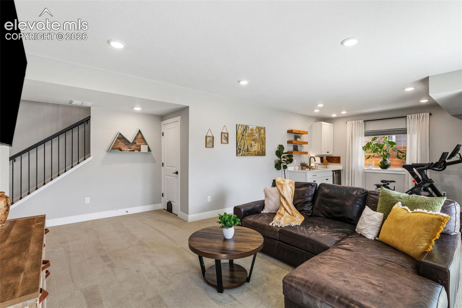 Great Room w/ wet bar on the right side and mechanical room/storage in the middle