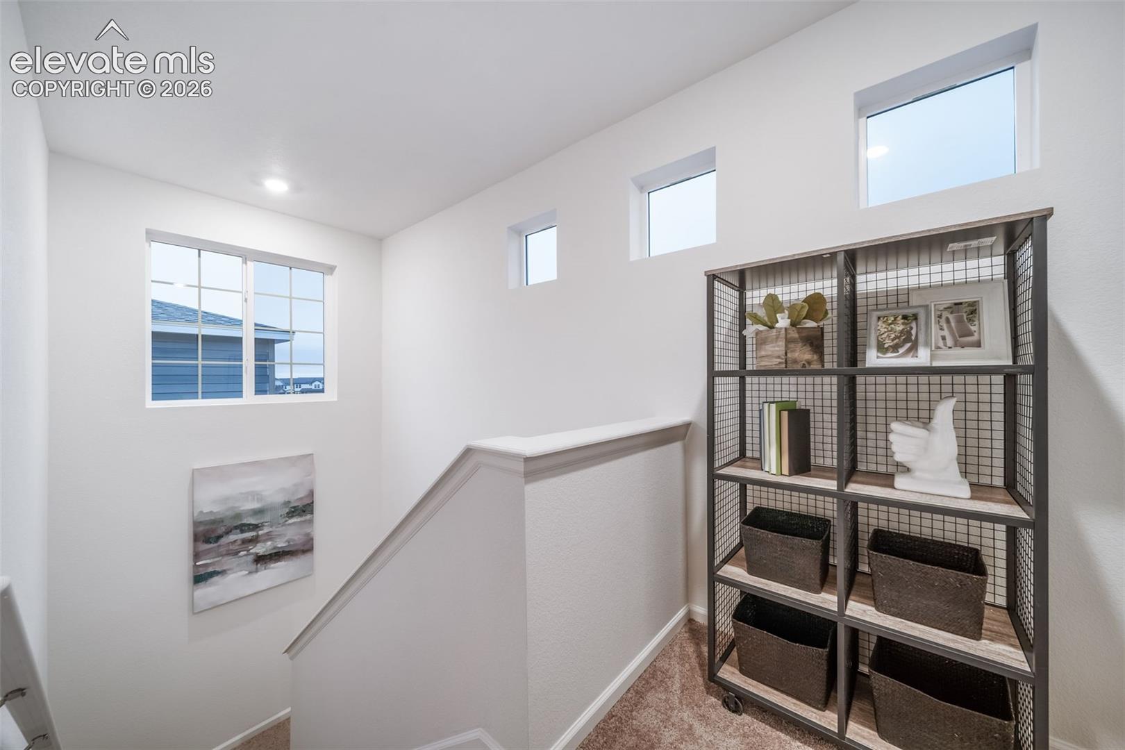 Built-in shelving unit with wood-finish shelves and metal framing
*photos of a model home*