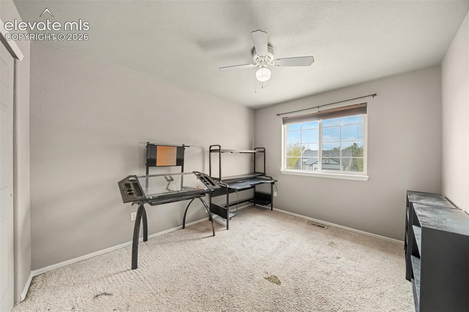 Bedroom #2 with a white ceiling fan with integrated light fixture