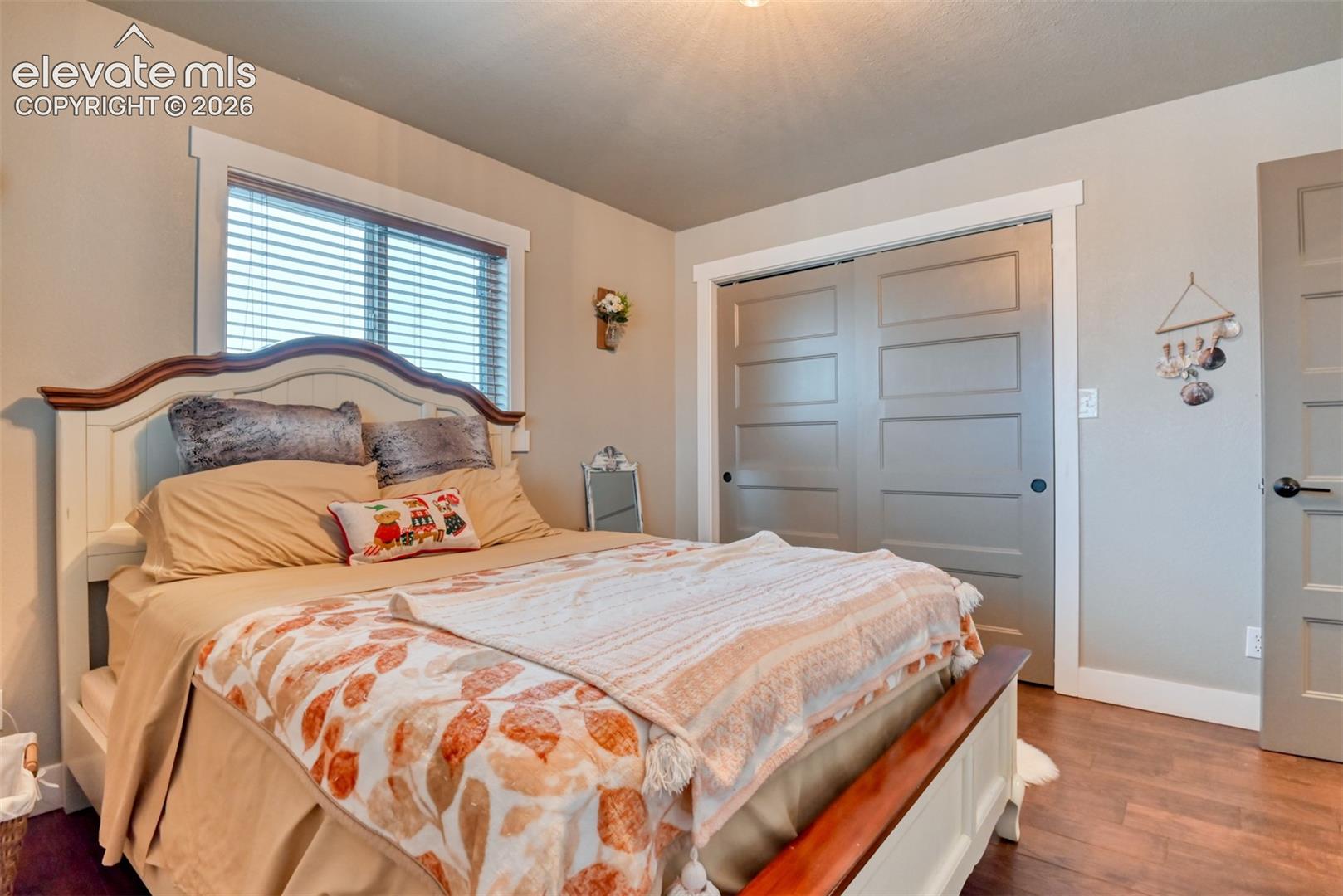 Bedroom with a closet and dark wood finished floors