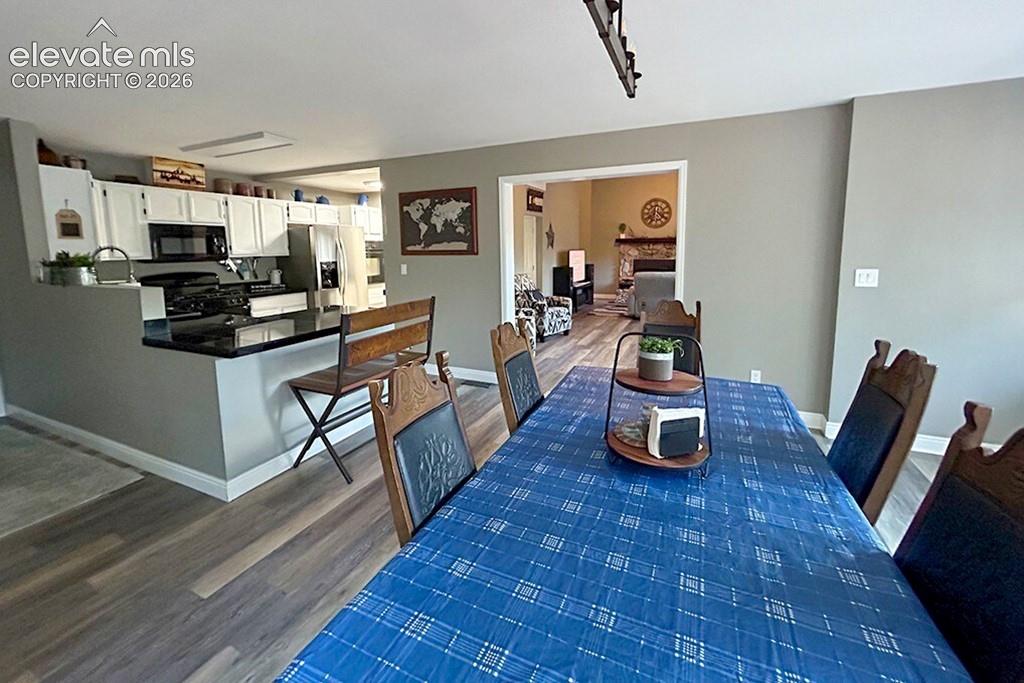 Open concept design, looking from front door to dining, kitchen, and living room