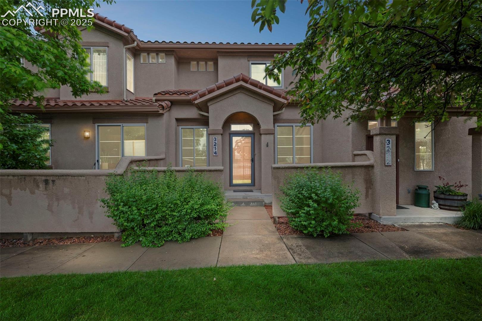 Mediterranean / spanish-style home with stucco siding and a tile roof