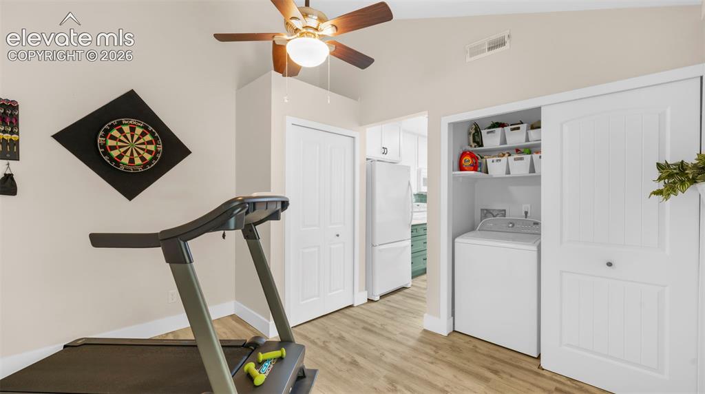Vaulted ceilings featuring a ceiling fan with integrated lighting