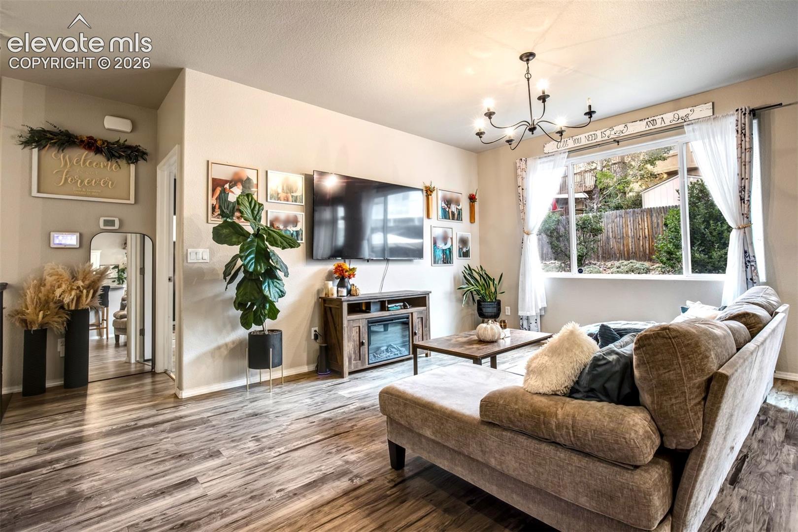 Door to the primary suite and view of the fully landscaped backyard