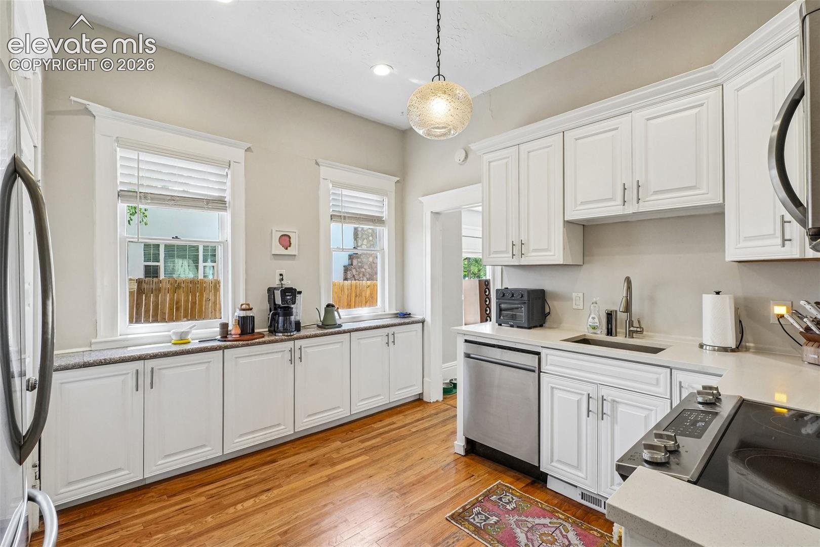 Kitchen with matching stainless steel appliances, wood flooring and plenty of cabinet space