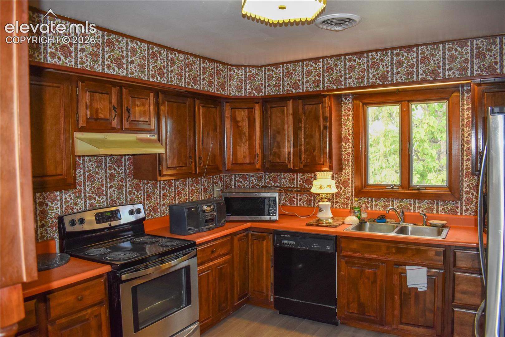 Wood-finish cabinetry paired with orange-hued countertops