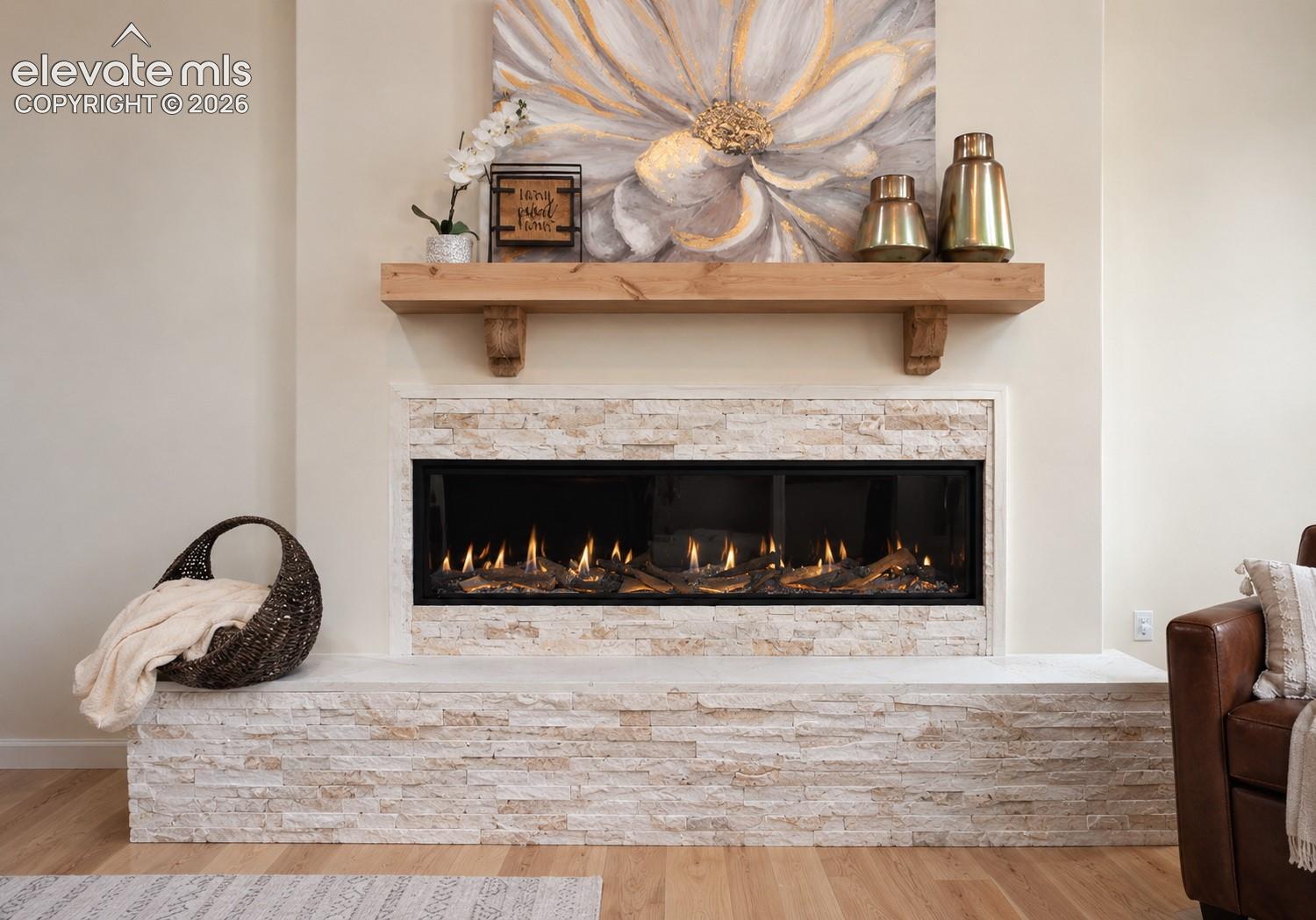 Integrated linear fireplace with stone surround, wood mantel, and light wood-finish flooring