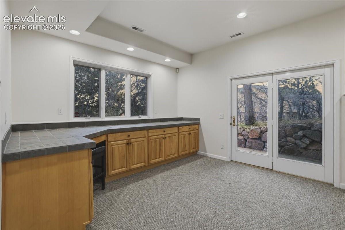 Built-in wooden cabinetry with a tiled countertop