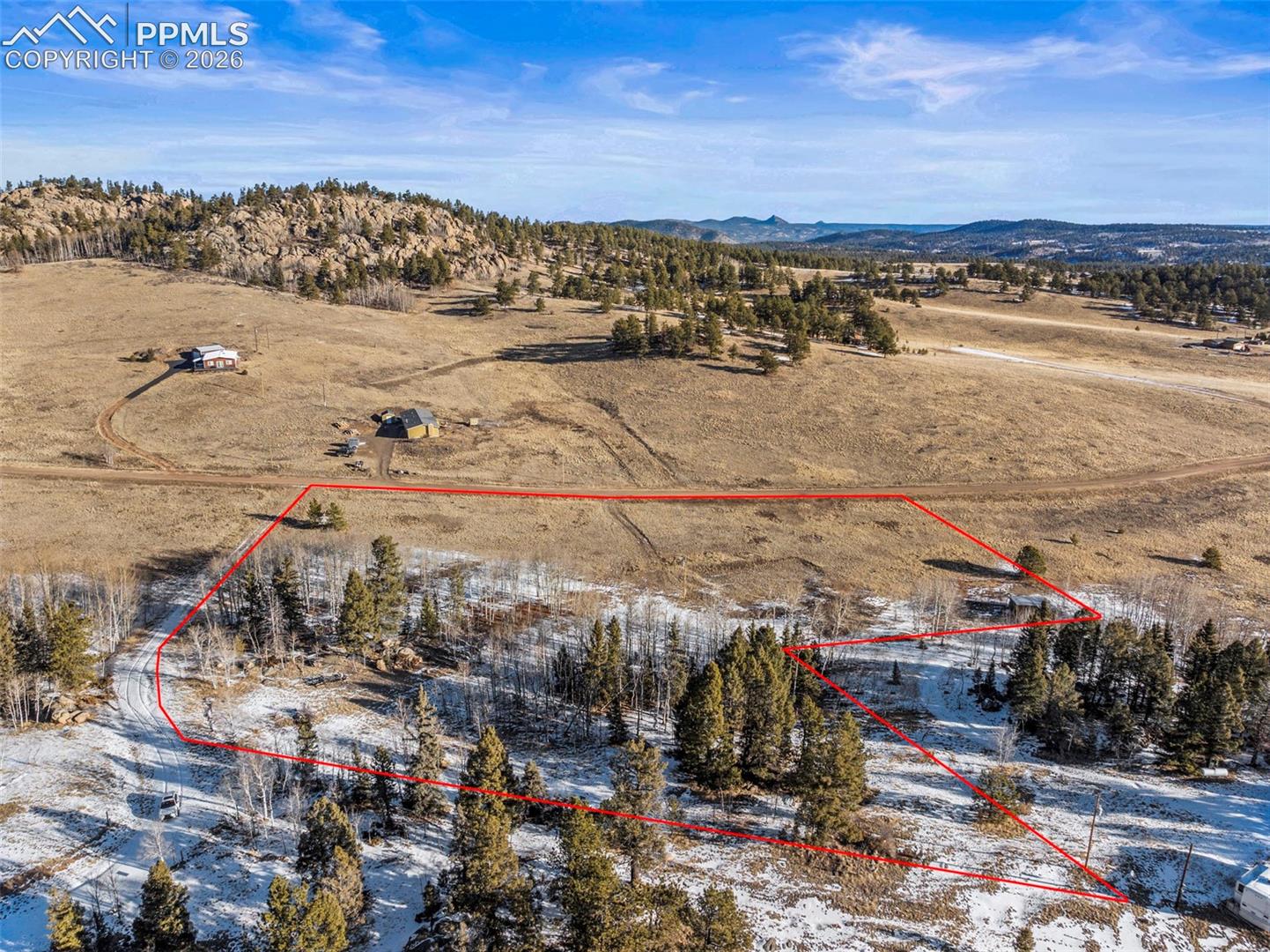 Overview of rural landscape featuring property boundaries highlighted and a mountainous background. Property Lines are Approximate and not a survey.
