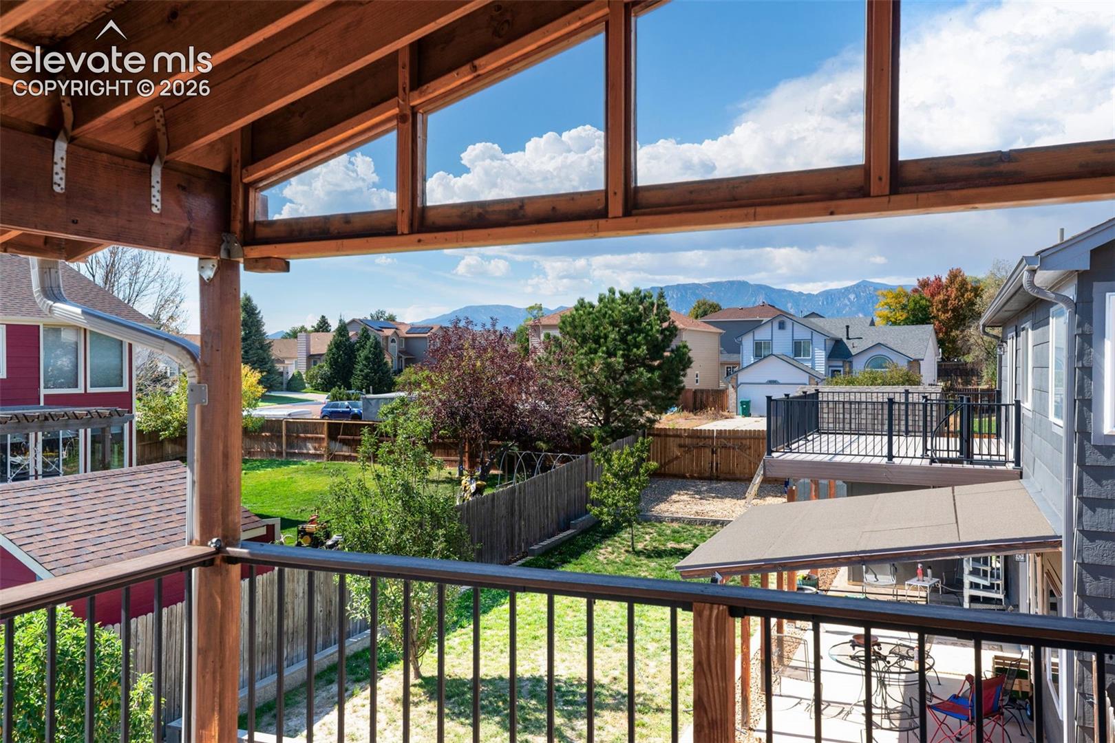 Covered outdoor living space featuring exposed wood beams and framing