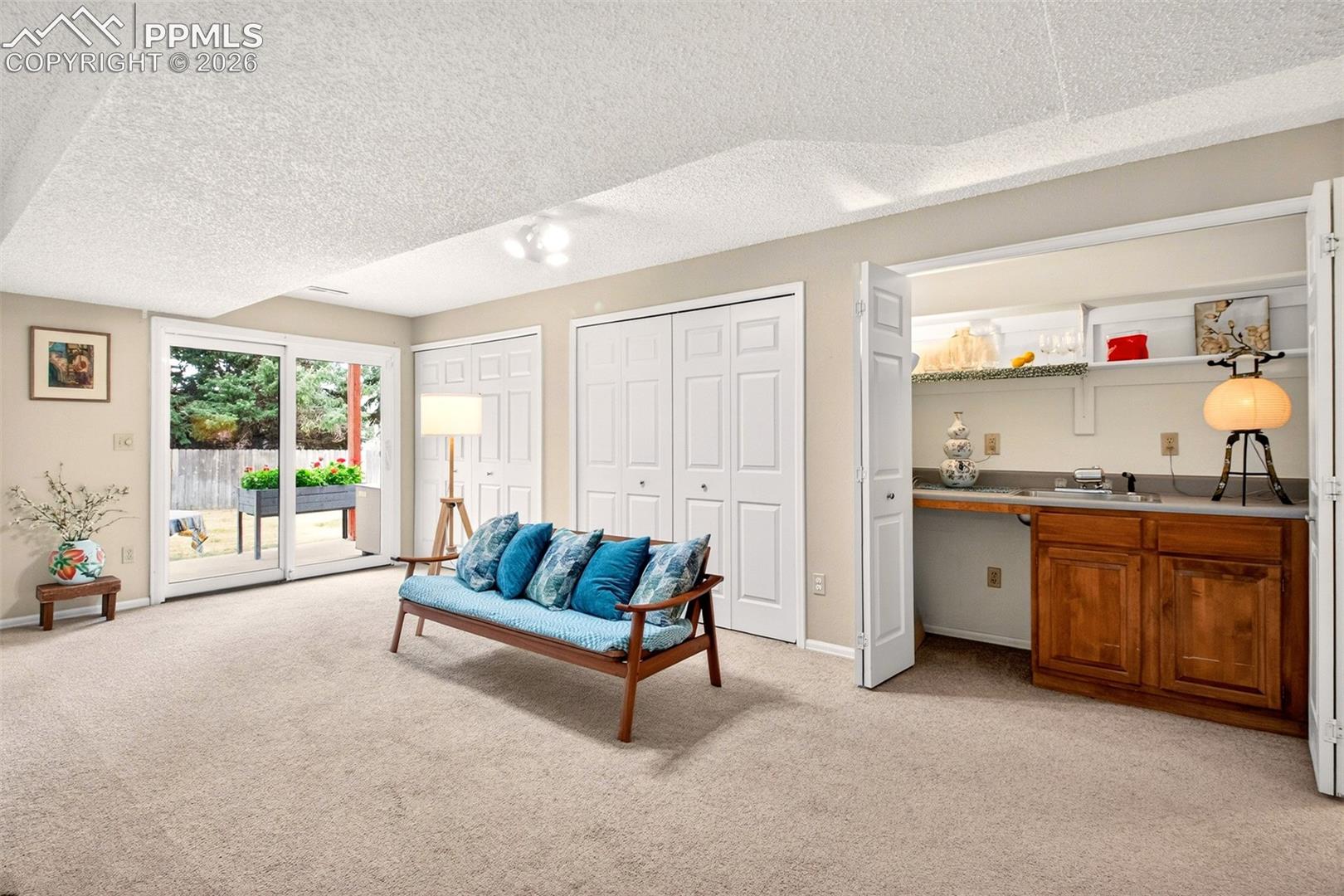 Spacious basement family room offering an abundance of strorage and a wet bar great for entertaining. Easy access to the newly poured concrete patio.