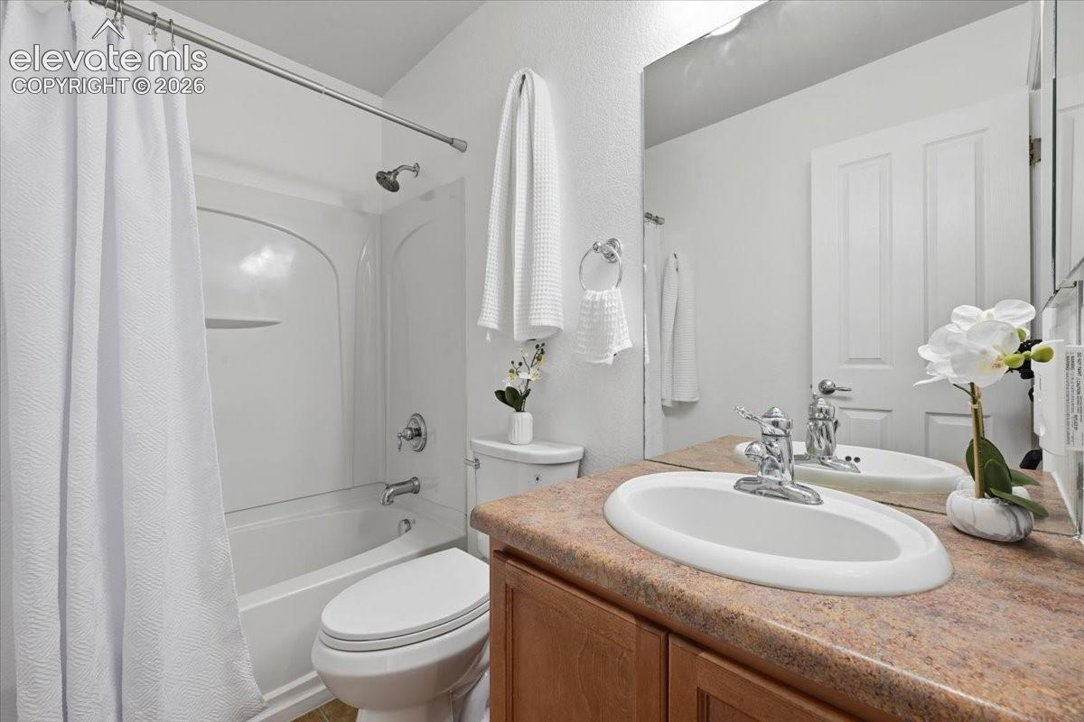 Secondary upstairs bathroom, White bathtub with shower, integrated wall storage, and chrome fixtures