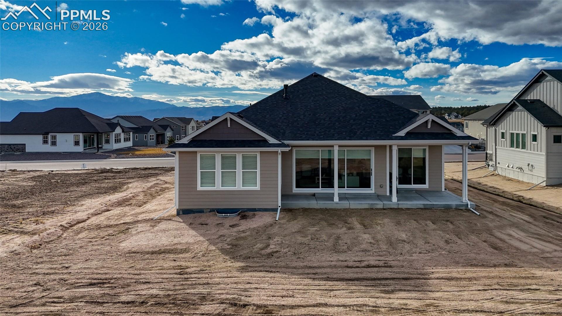 Back of property featuring a patio and a residential view