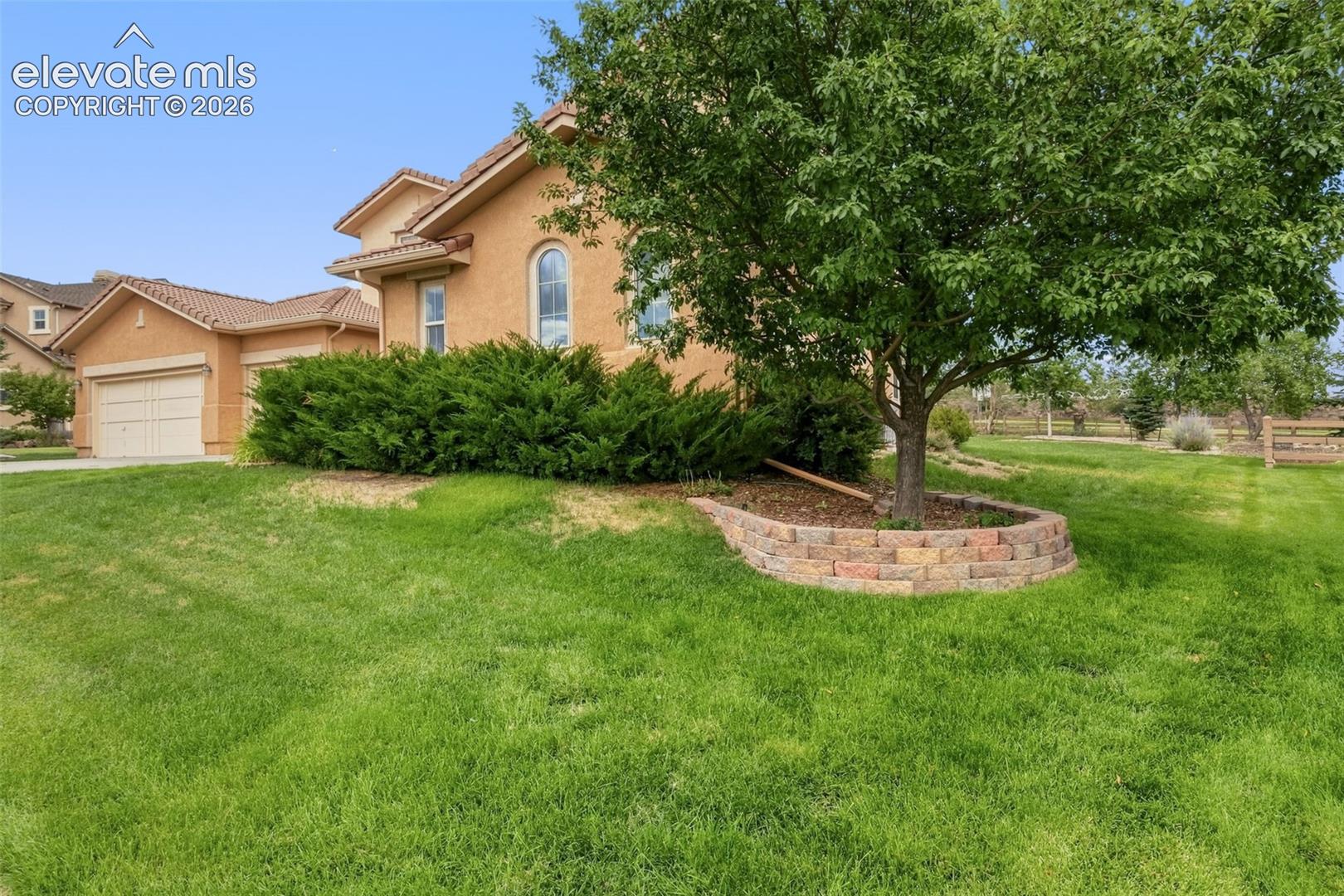 Tuscan-style exterior with a tile roof and arched windows