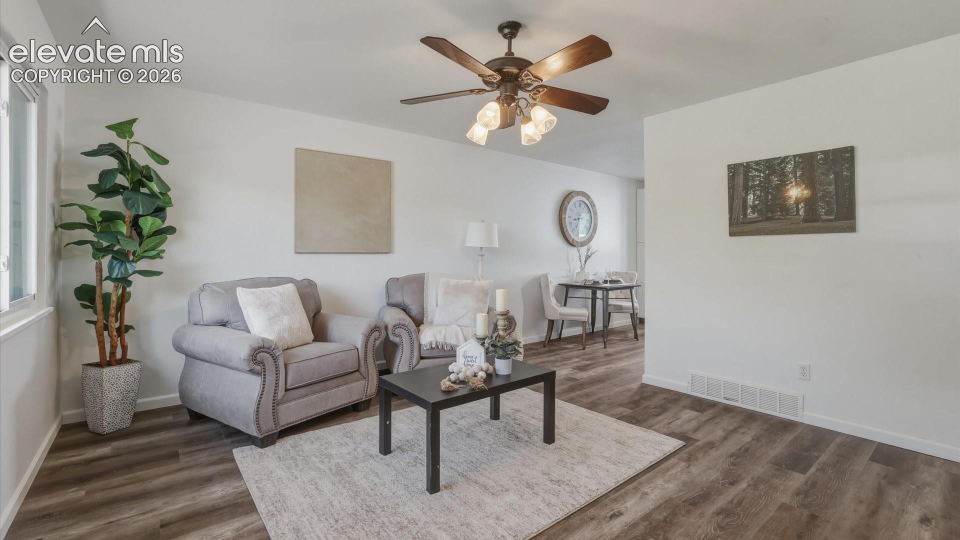 The Living Room flows seamlessly into the Dining Area and Kitchen.