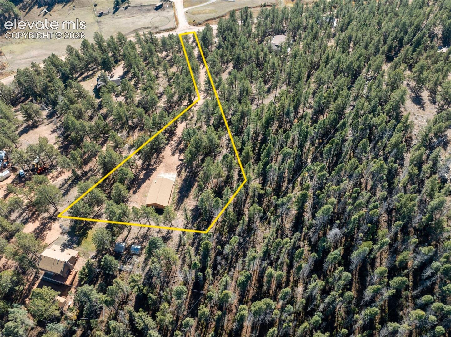 Aerial view of included Lot 111 with 1536 sq ft workshop (2.86 acres). Property Lines are Approximate and not a survey.