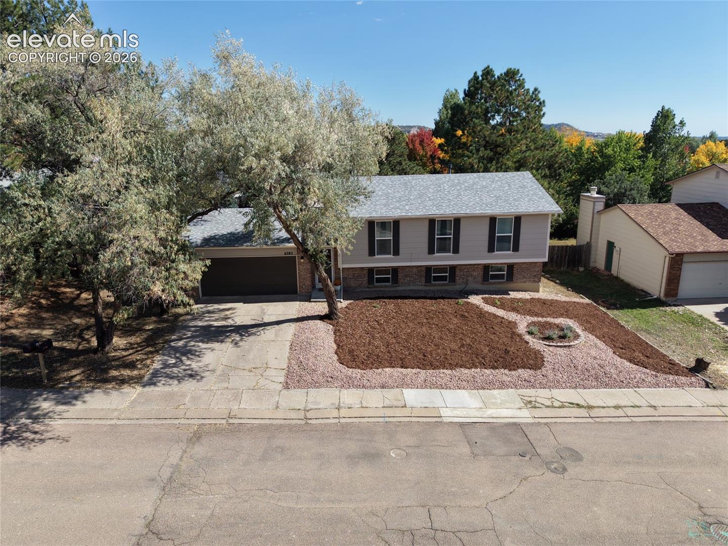 Welcome home to this beautifully UPDATED, move-in-ready home in the desirable Rockrimmon neighborhood! Featuring a functional floor plan, a primary bedroom with an attached bathroom, a beautifully remodeled kitchen, an oversized 2-car garage, no popcorn ceilings, mountain views, and a fully fenced backyard, this home offers a wonderful combination of comfort, style, and convenience.The covered entry opens to a spacious foyer with luxury vinyl plank flooring, a large coat closet, and access to the attached garage featuring overhead storage and access to the backyard.The upper level offers an open living and dining area with recessed lighting, a ceiling fan, and large west-facing windows showcasing mountain views. The beautifully UPDATED kitchen features leathered granite countertops with natural chiseled edges, stainless steel appliances, an island with breakfast bar seating, custom cabinet hardware, a glass tile backsplash, and a large pantry.  The kitchen also provides direct walk-out access to the backyard deck, making it convenient for outdoor dining and entertaining.The primary bedroom overlooks the backyard and includes a walk-in closet and access to the full bathroom with granite countertops and an UPDATED vanity. A second bedroom with a walk-in closet completes the upper level.Downstairs, you'll find a family room with recessed lighting, two additional bedrooms, an UPDATED 3/4 bathroom with a tiled shower, and a laundry closet with modern shelving.The fully fenced backyard offers a large deck, NEWER storage shed, and landscaping improvements. The front yard was completely REFRESHED in 2026.MAJOR improvements include a NEWER roof, A/C, and water heater in 2022, and sewer line replacement in 2024.Conveniently located near Rockrimmon Open Space, Ute Valley Park, Golden Hills Park, shopping, restaurants, and neighborhood amenities, this home offers easy access to outdoor recreation and everyday conveniences. Come take a look!