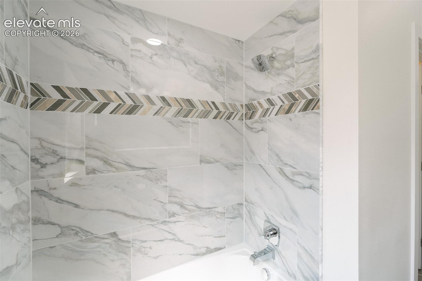 Tiled tub/shower in the upper level Full Bathroom.