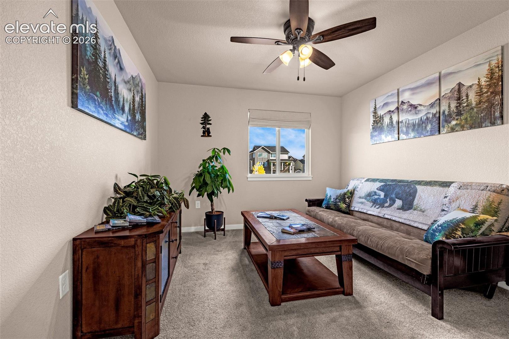 Neutral interior room featuring neutral wall paint, carpeted flooring, a ceiling fan with integrated lighting, and a single-pane window. Closet not pictured.