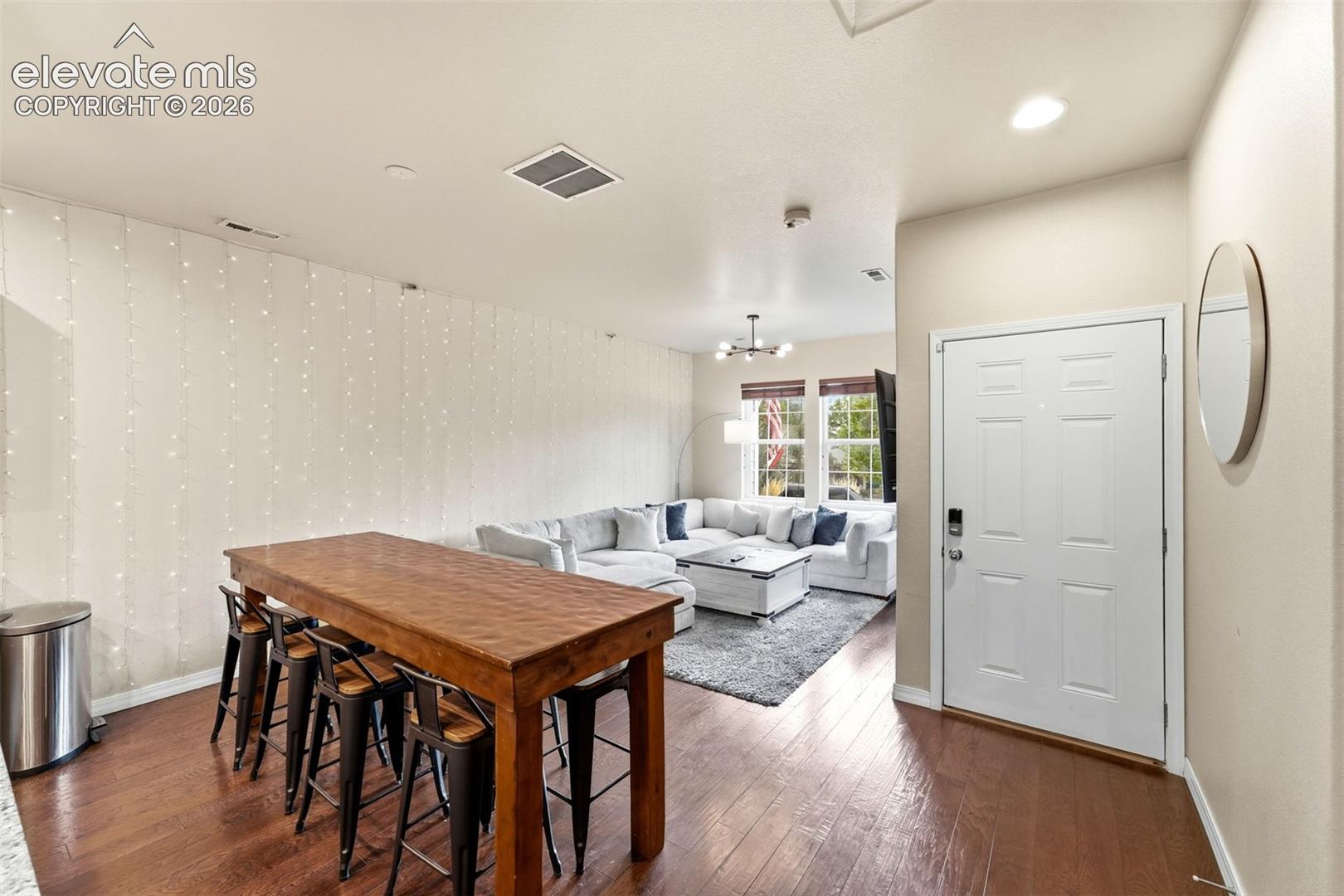 Warm wood-finish flooring extending from the entryway