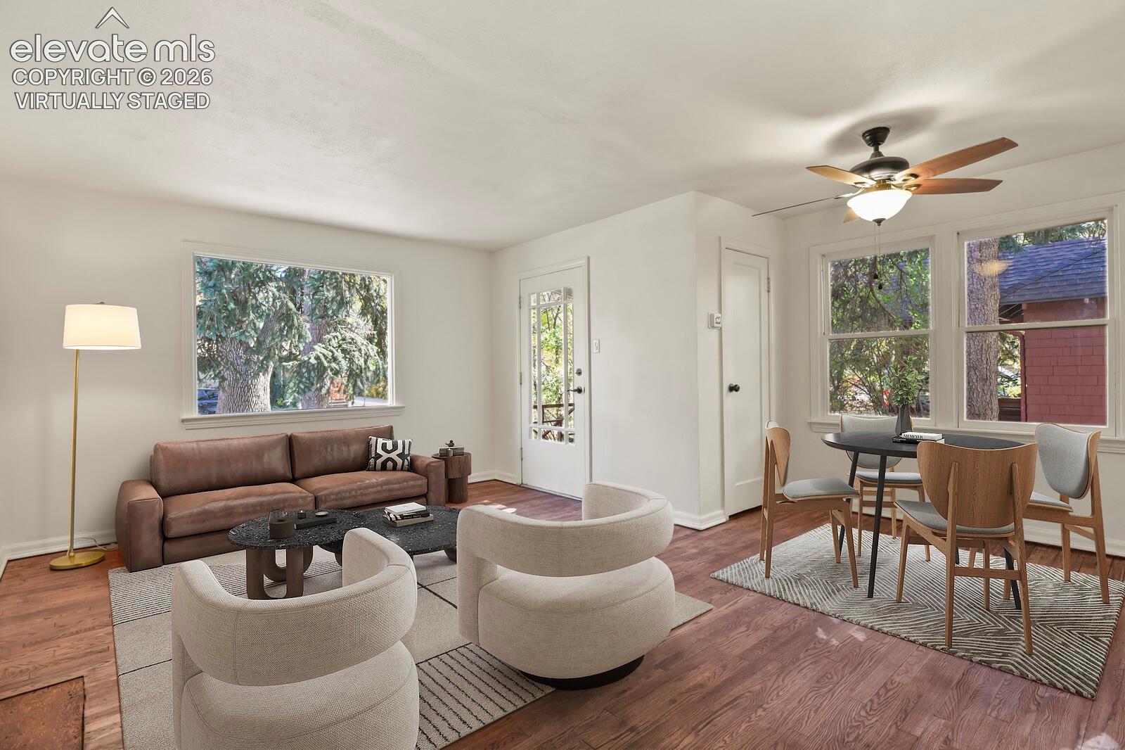 Virtually staged. Wood-finish flooring, large bay window, and a ceiling fan 