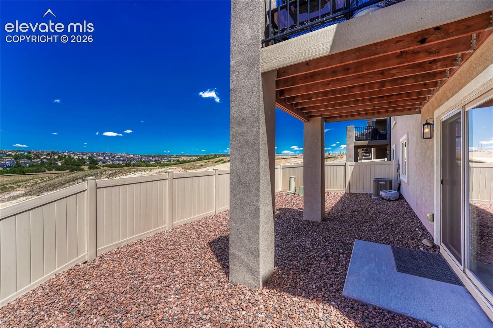 The covered patio offers a private outdoor retreat with low-maintenance landscaping and room to personalize the space.