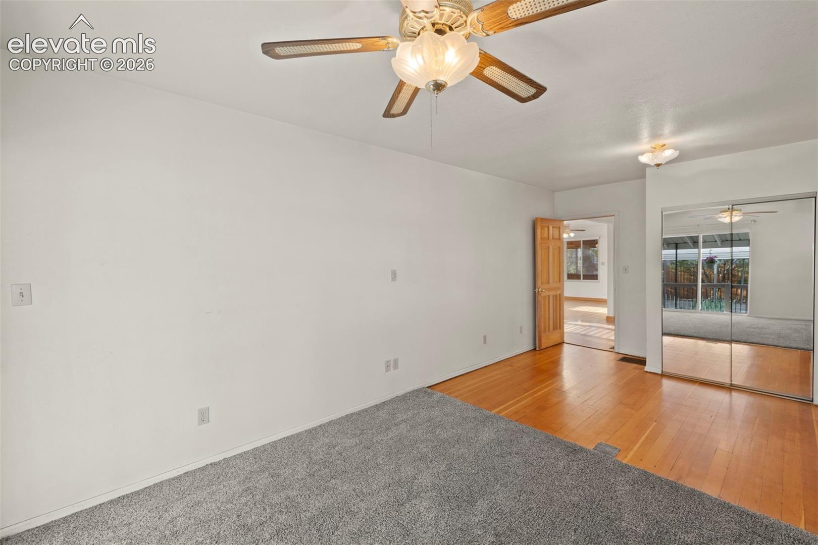 Wall-to-wall carpeting and wood-finish flooring