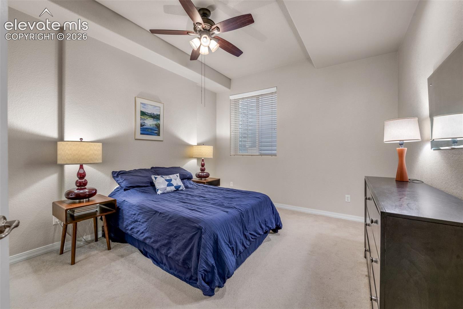 Recessed ceiling with a dark wood-finish ceiling fan and attached lighting